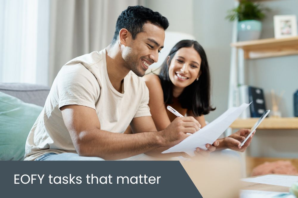 EOFY tasks that matter Couple sitting on couch doing finances
