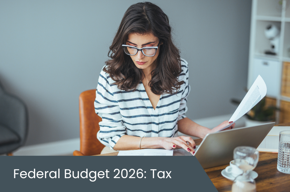 Federal Budget Tax Young woman on laptop doing taxes