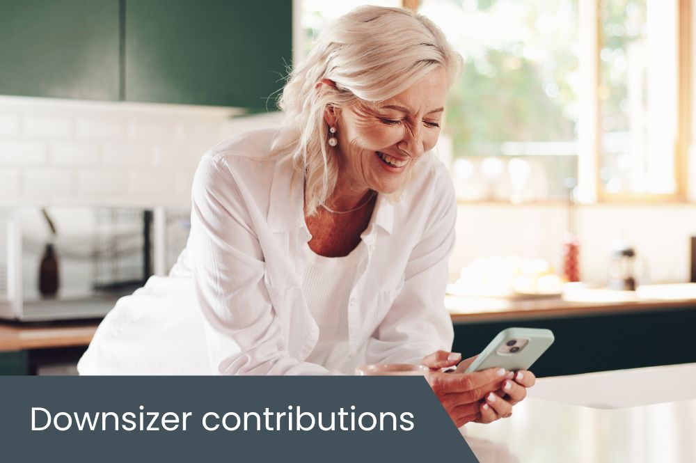 Downsizer contributions Woman looking at her phone in kitchen