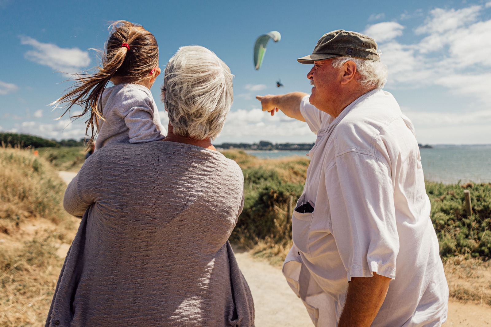 Elderly couple with granddaughter by the sea