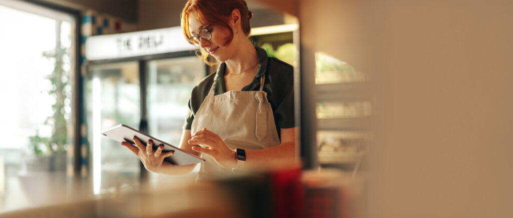 Business owner using a tablet in a café