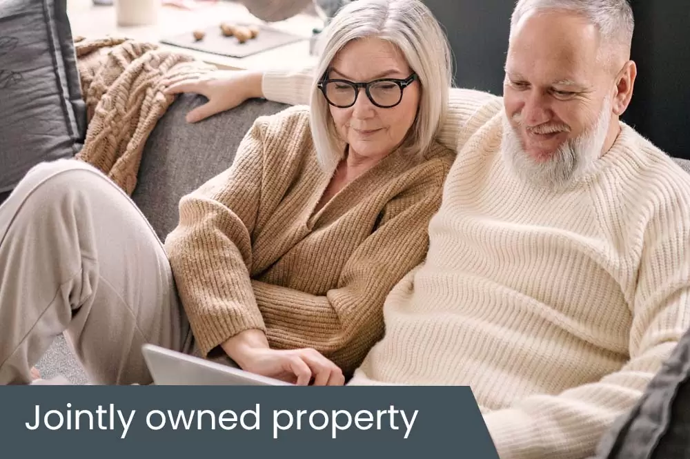 How does a jointly owned property affect aged care fees
