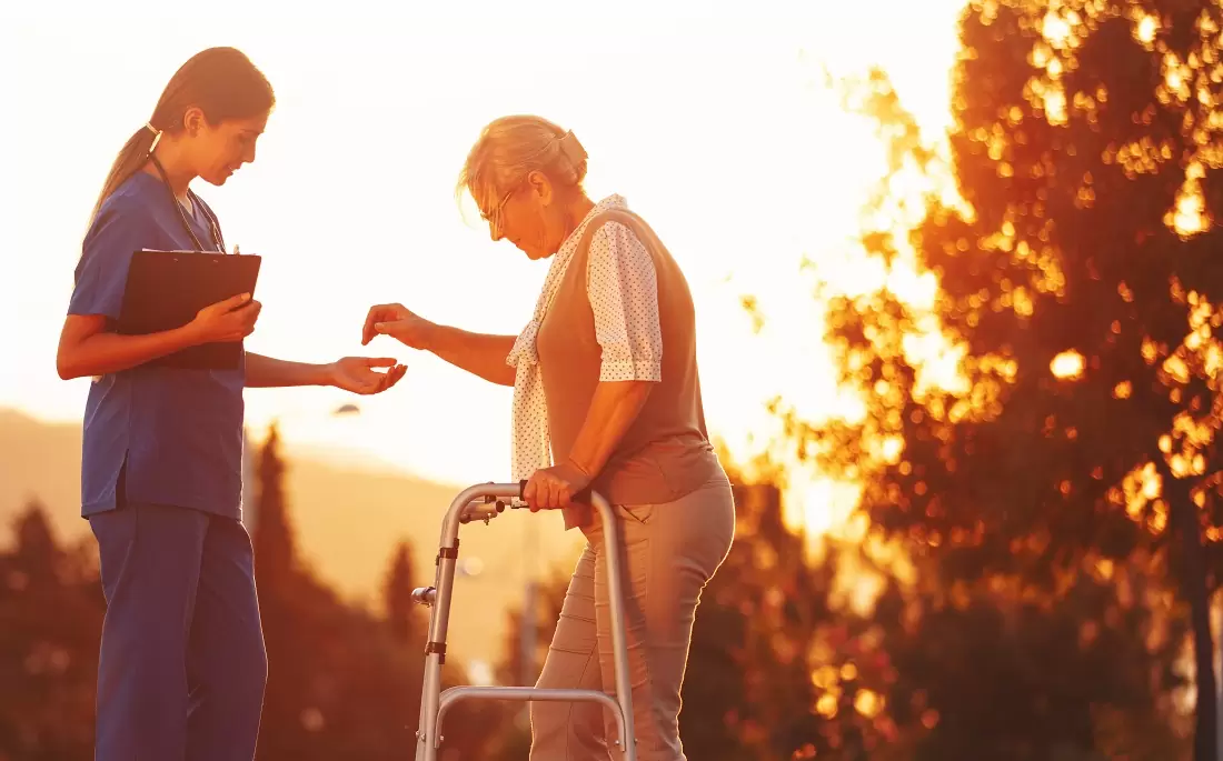Nurse helping old woman for comfort and care