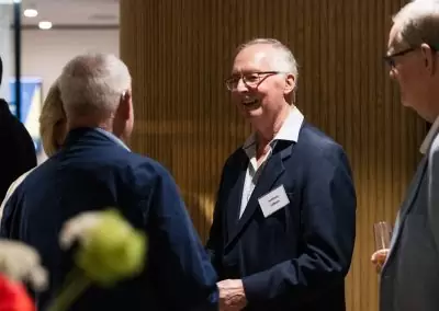 3 men talking at event