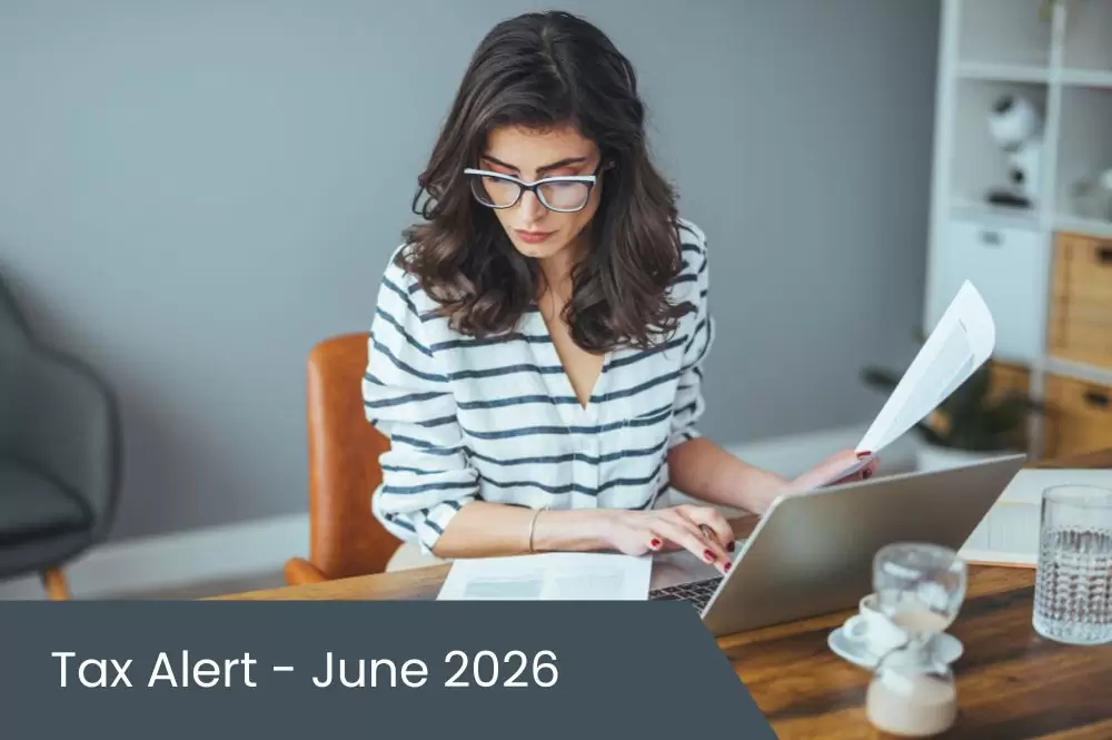 Tax Alert – June 2026 Young woman doing taxes on laptop