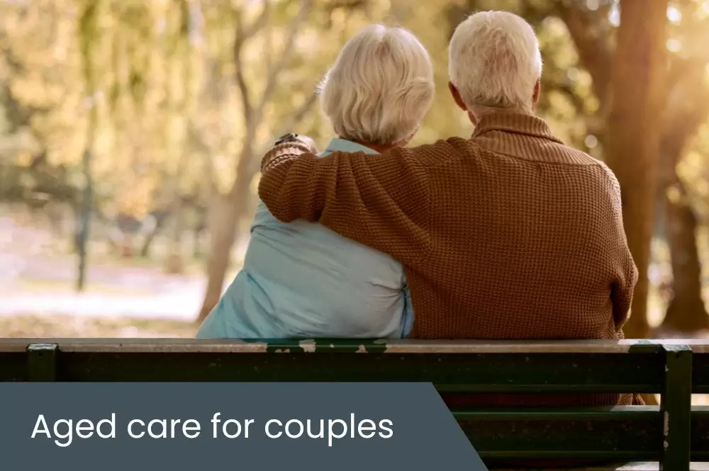 Aged care for couples Elderly couple sitting on park bench